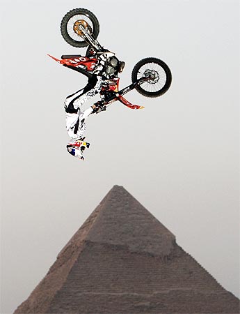 A biker performs in front of the Great Giza pyramids during Red Bull Fighters International Freestyle Motocross 2009 Exhibition Tour on the outskirts of Cairo on April 10, 2009