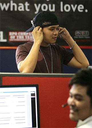 Sitel employees take calls from international customers at its new facility in Pasig City, Metro Manila on May 20, 2009