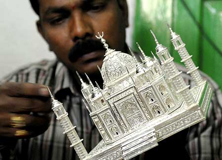 Silversmith Krishna Chary works on a miniature replica of the historic Taj Mahal.