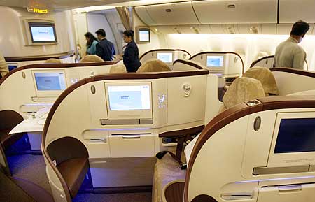 People look at the newly introduced premier class cabin in a Jet Airways Boeing 777-300 ER.