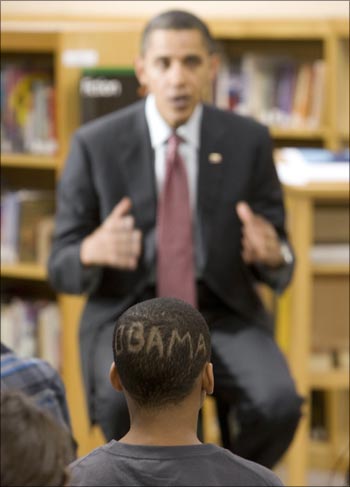 A student with an 'Obama haircut' at Wright Middle School in Madison, Wisconsin, listens to US President Barack Obama speak.