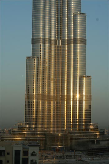 The exterior of the Burj Tower turns gold as the sun rises.
