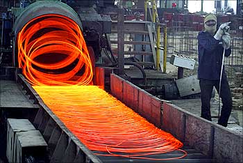 A labourer works inside a steel factory in Kanpur.