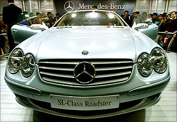 Visitors admire a Mercedes Benz SL500 model during the 7th Auto-Expo 2004 in New Delhi.