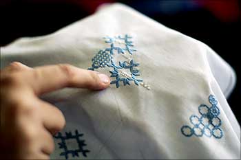 An Afghan woman works on a form of embroidery called Khamak at Kandahar Treasure facilities.