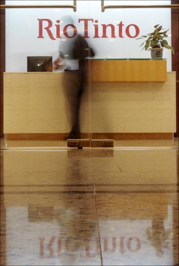 An employee walks past the reception area at the Rio Tinto Ltd Shanghai office.