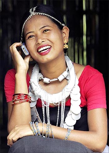A girl from the Dhimal tribe, one of India's smallest tribal communities, talks on her mobile phone.