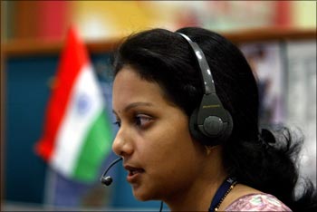 An Indian employee at a call centre provides service support to international customers.