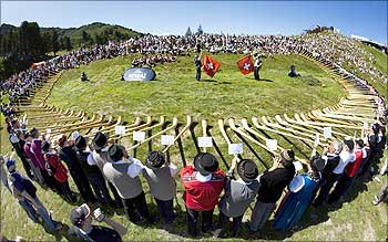 Alphorn blowers perform during the international alphorn contest on the alp of Tracouet in Nendaz, southern Switzerland.
