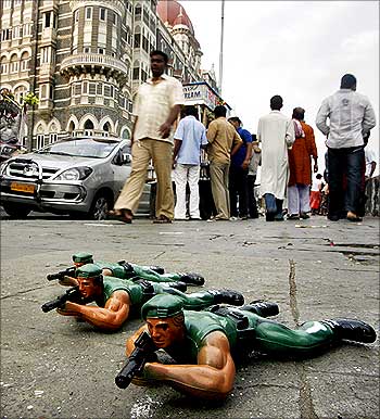 Toy soldiers are displayed for sale by a street hawker in front of the Taj Mahal Hotel.