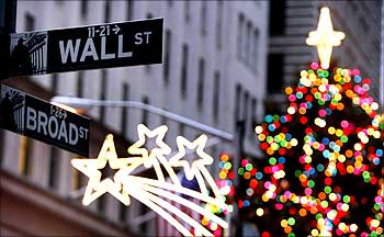 The Wall Street sign is seen in front of Christmas decorations on the first trading day of 2009 outside of the New York Stock Exchange.