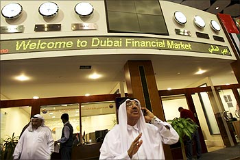 An investor talks on the phone at the opening of Dubai Financial Market.