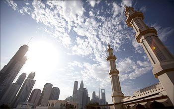 The twin minaretes of a mosque are seen with office towers along Sheikh Zayed Road in Dubai.
