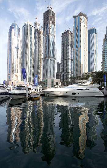 Residential tower blocks are reflected in the waters of Dubai Marina.