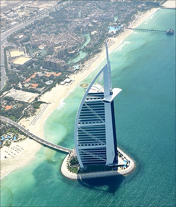An aerial image with the Burj Al Arab in the foreground.
