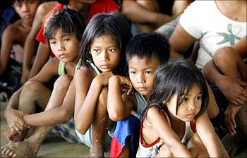 Children from flood-hit town Rosales, Pangasinan wait for the distribution of relief supplies by US Marines.