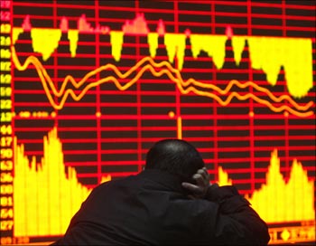 A man looks at an electronic board at a securities exchange in Wuhan, Hubei province, China.