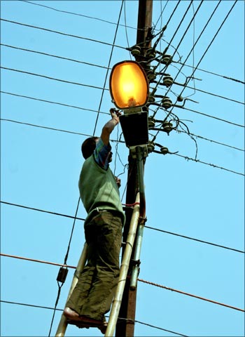 An Indian electrician repairs power lines in Siliguri.