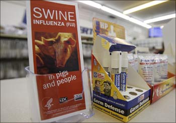 An informational pamphlet about influenza A (H1N1) displayed on the counter beside a box hand sanitizers.