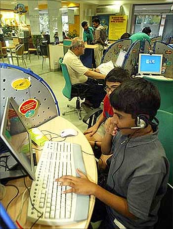 Children play computer games at an Internet cafe by run by Reliance Infocomm in Kolkata.