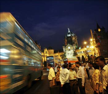 A double-decker bus goes past Chhatrapati Shivaji Terminus railway station in Mumbai.