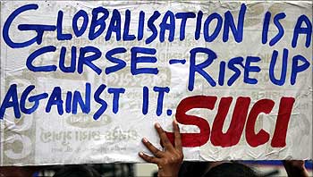 A supporter of Socialist Unity Centre of India (SUCI) holds a placard during a protest against the World Trade Organisation ministerial in Ahmedabad.