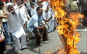 Activists burn an effigy depicting World Trade Organisation in New Delhi.
