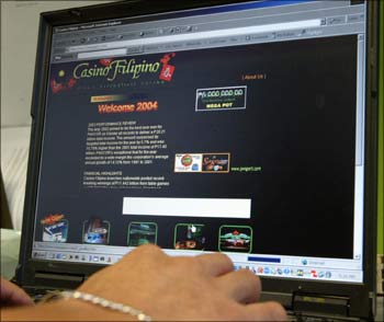 An employee of Philippine casino operator surfs the Internet.