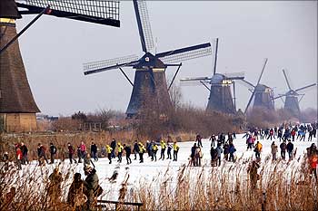 Skaters enjoy the scenery of windmills at the UNESCO World Heritage site in Kinderdijk, the Netherlands.