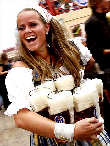 An Oktoberfest waitress carries beer after the opening ceremony of the Oktoberfest in Munich.