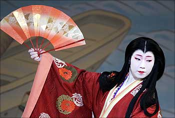 A geisha performs during an annual spring dance performance at a theatre in Kyoto, Japan.