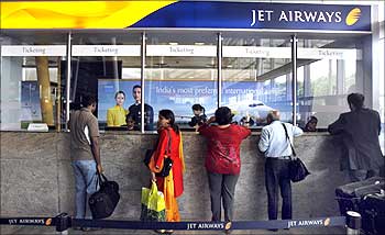 Passengers speak with employees at the Jet Airways ticketing counter at the domestic airport in Mumbai on Sep 8.