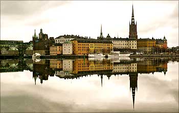Stockholm's Gamla Stan or old town district is reflected in calm waters.
