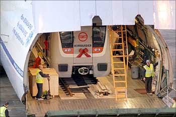 An imported Metro rail carriage is being taken out from the aircraft.