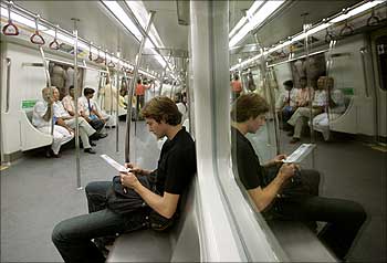 Passengers sit inside a carriage of the Delhi Metro rail.