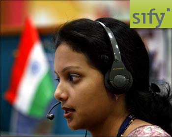 An employee at an BPO unit in Mumbai. (Inset) Sify logo