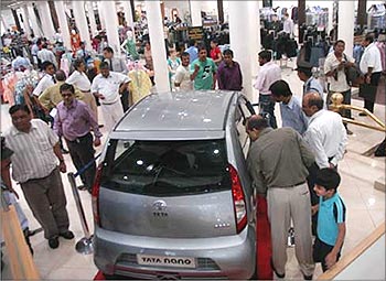 Customers take a look at the Tata Nano in Mumbai.