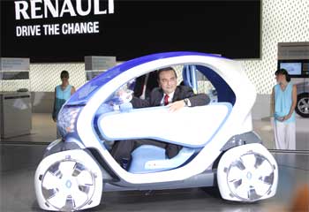 Carlos Ghosn, President and Chief Executive Officer of Renault sits in a Twizy Z.E. concept.