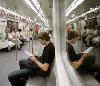 Passengers inside a carriage of the Delhi Metro rail.