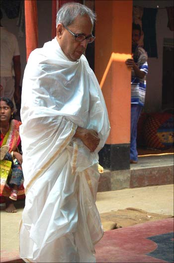 Pranab Mukherjee clad in a dhoti and uttoriyo for the puja.
