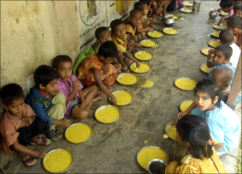 Students have a free meal distributed by a government-run school in Nalchar village, near Agartala.