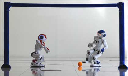 A robot gets ready to score a goal.