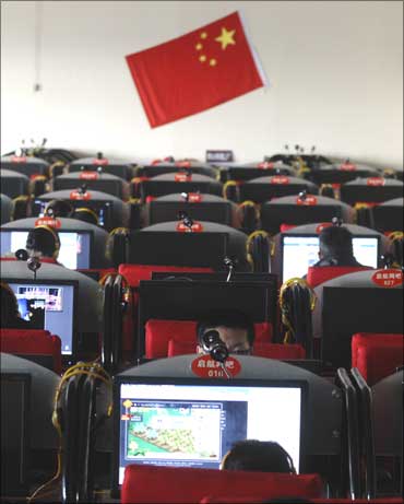 People use computers at an Internet cafe in Changzhi, Shanxi province, China.