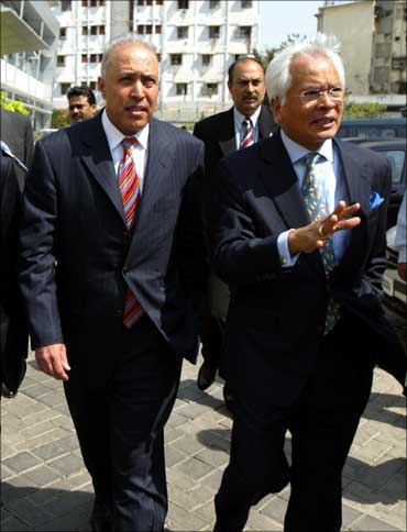 Former Vodafone CEO Arun Sarin (left) walks with former Hutchison Essar CEO Asim Ghosh in Mumbai