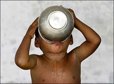 A child drinks water at a flood relief camp in Araria district town in Bihar.