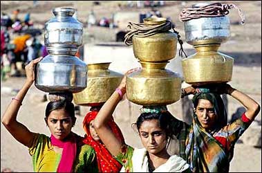 Women carry pitchers filled with drinking water at Siyani village, about 130 km northwest from Ahmedabad.