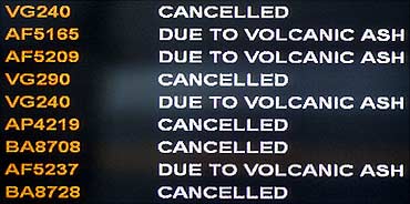 A screen informs passengers that all flights have been cancelled after ash from a volcanic eruption.