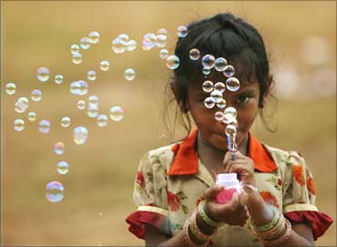 A girl selling bubble-making toys in Mumbai.