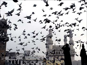 Birds fly off at Charminar in Hyderabad.