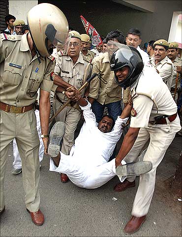 This file photo shows police detaining an activist of Samajwadi Party during a protest against rising inflation in Allahabad.